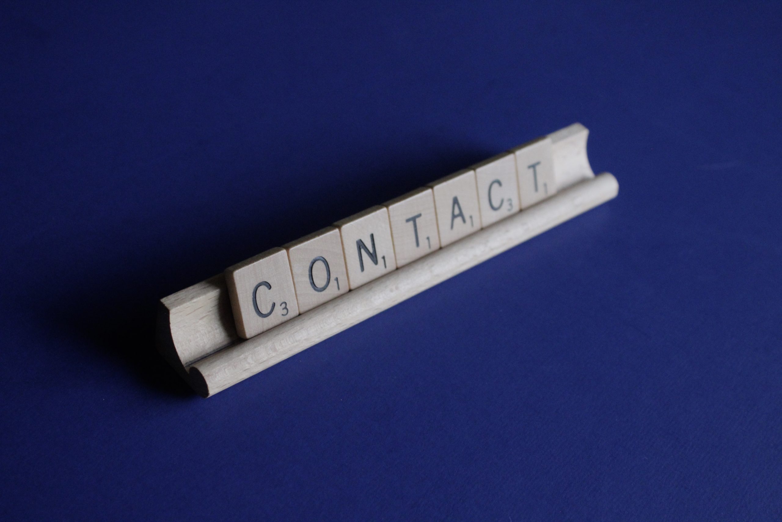 Scrabble letters spelling "contact"